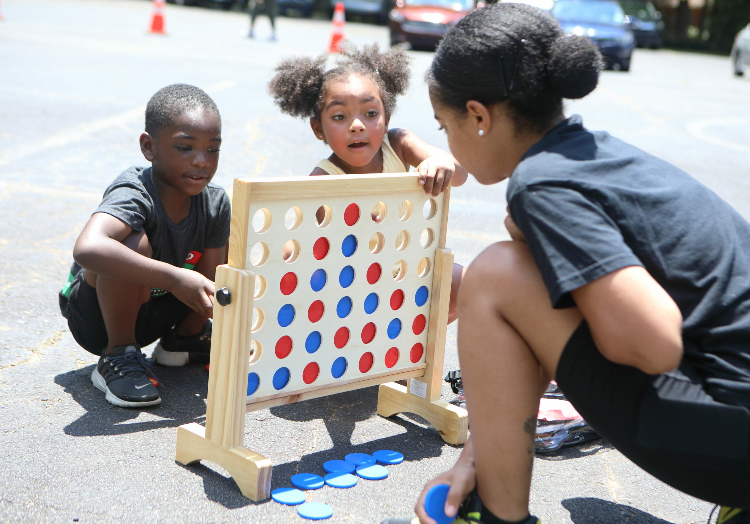 Photo of a volunteer with children playing a game.
